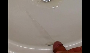 Pissing in hotel bathroom sink