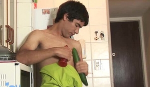Freaky boy plays with long and thick veggies and fruit