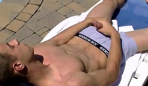 Jake Washington jerks off his dick by the swimming pool